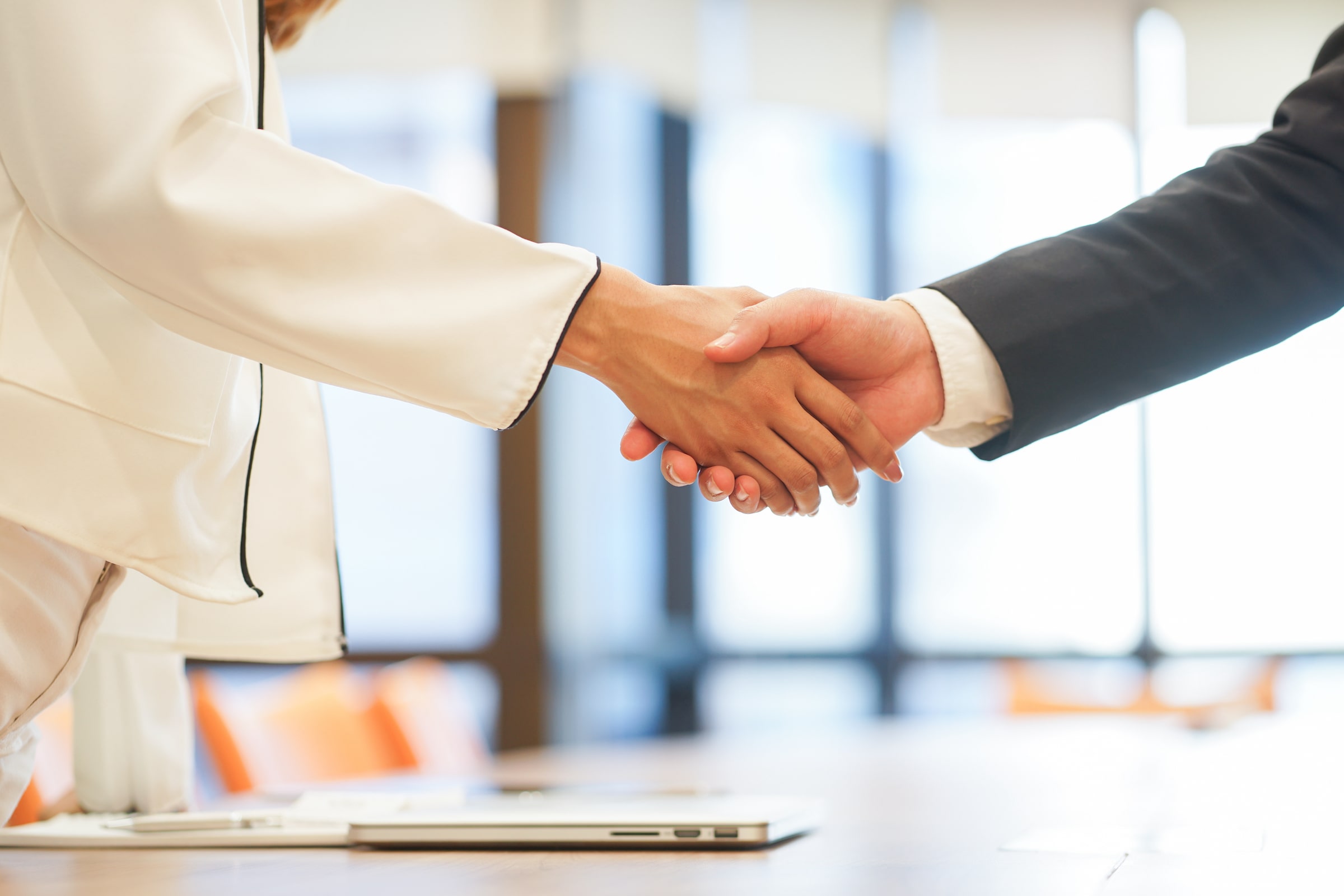 Man and woman shaking hands, making an agreement