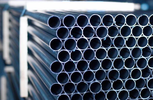 steel pipes stacked up, ready to be distributed